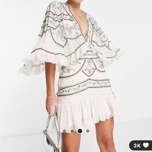 ASOS DESIGN lace trim mini dress with cape sleeve and floral embellishment